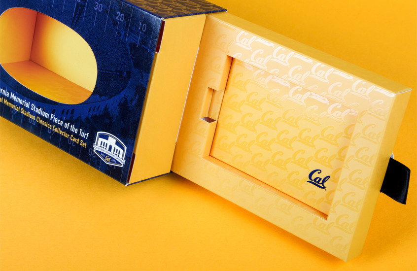 California Golden Bears Football - Collectible Merchandise — Displayed in a highly finished pack, our clever reveal for the California Golden Bears football team held a piece of the original stadium turf and set of trading cards, completing the presentation for this prized collectors piece.