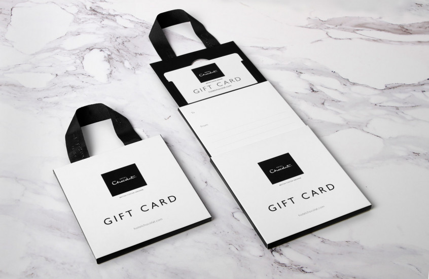 Hotel Chocolat - Gift Card — Gift card packaging with writable messaging areas and a ribbon handle.